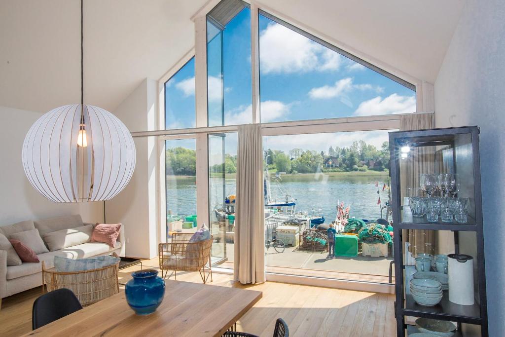 a living room with a large window with a view of the water at Netzschuppen 2 in Kappeln