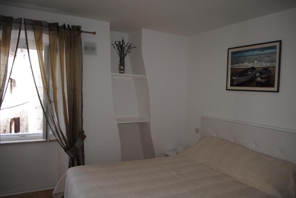 Postel nebo postele na pokoji v ubytování Rooms Piazzetta