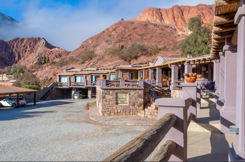 a row of houses with a mountain in the background at Hostería Terrazas de la Posta in Purmamarca
