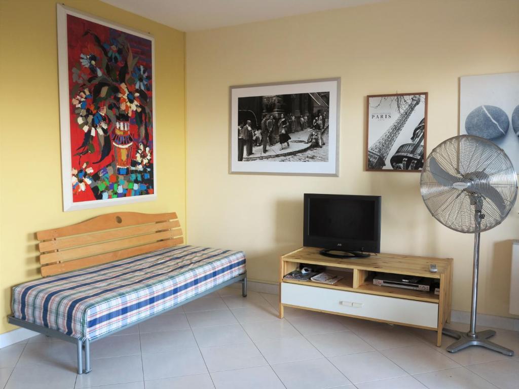 a room with a bed and a fan and a television at Villa Anna "Davvero sulla Spiaggia" in Vasto