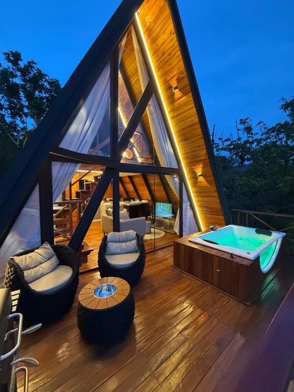 a house with a jacuzzi tub on a deck at Nature Senses Chapadinha in Cavalcante