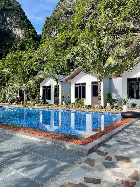 a house with a swimming pool in front of a mountain at Foresta Ninh Binh Homestay in Ninh Binh