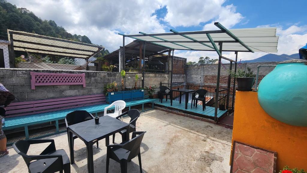 a patio with a table and chairs and a pool at Embajada Inn in San Cristóbal de Las Casas