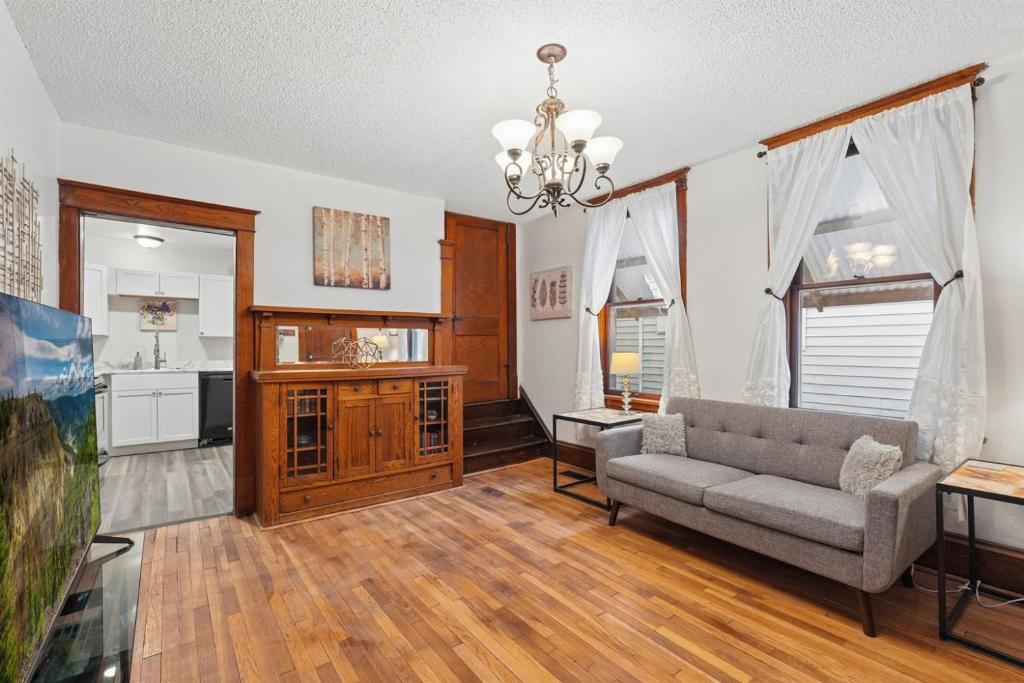 a living room with a couch and a kitchen at Spacious 2BR Across from Como Lake - Bramble in Saint Paul
