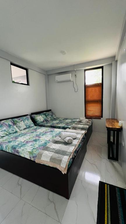 a bedroom with a large bed in a room at Belga Boarding House in Guimaras