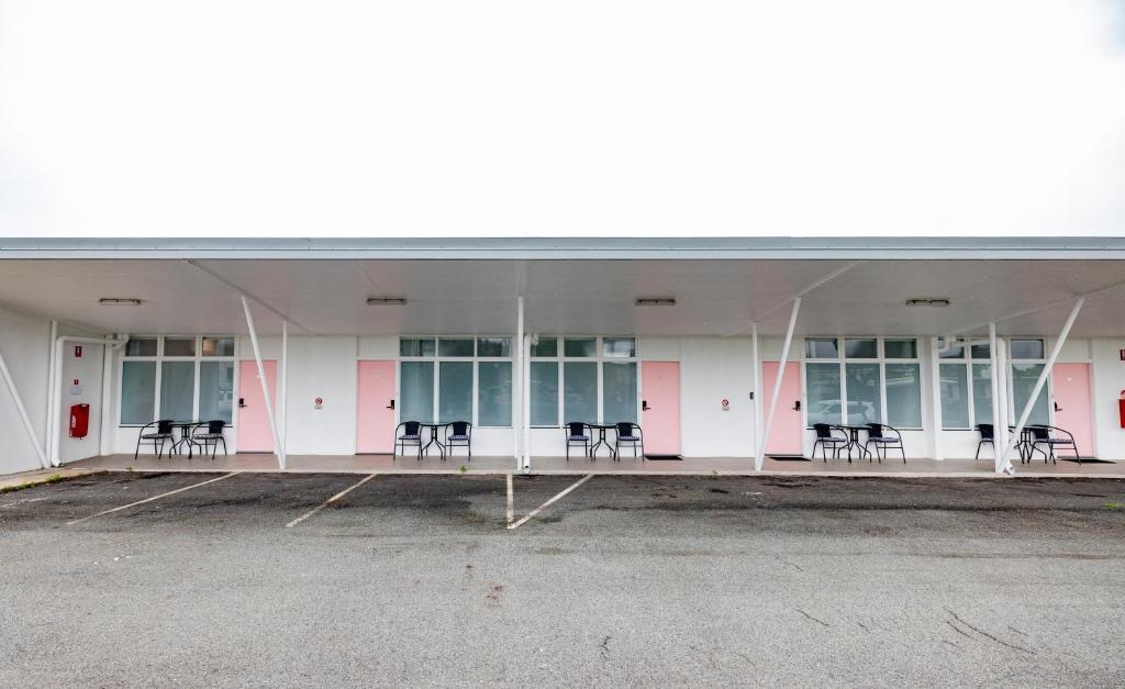 a group of chairs sitting inside of a building at Proserpine Motel in Proserpine