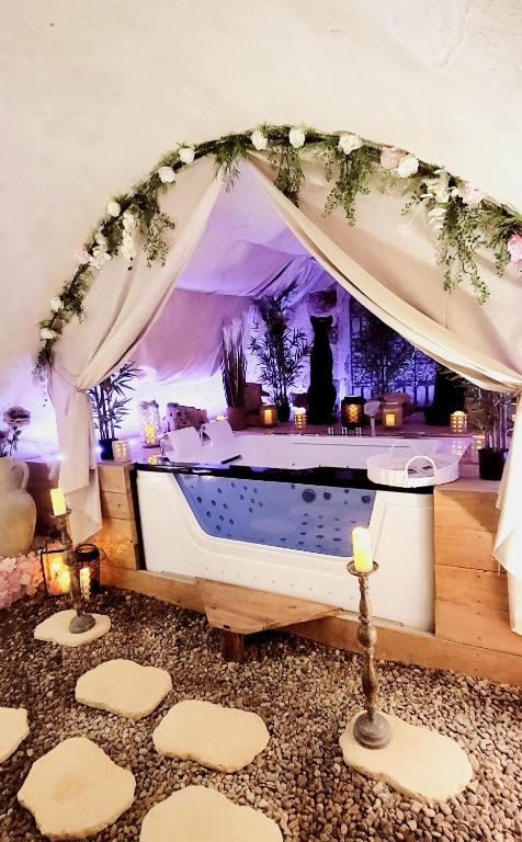 a spa with a tub in a room with a tent at L'Atelier Des Roses, Lunéville centre in Lunéville
