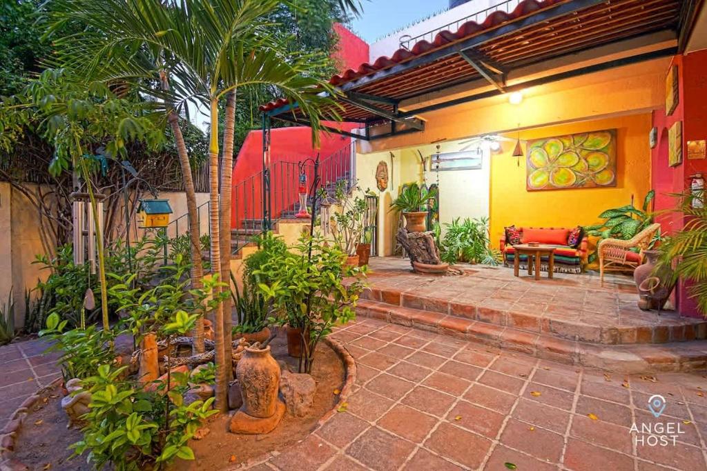 a house with a patio with a lot of plants at Beachside Bliss Suite 1 Block from Malecon in La Paz