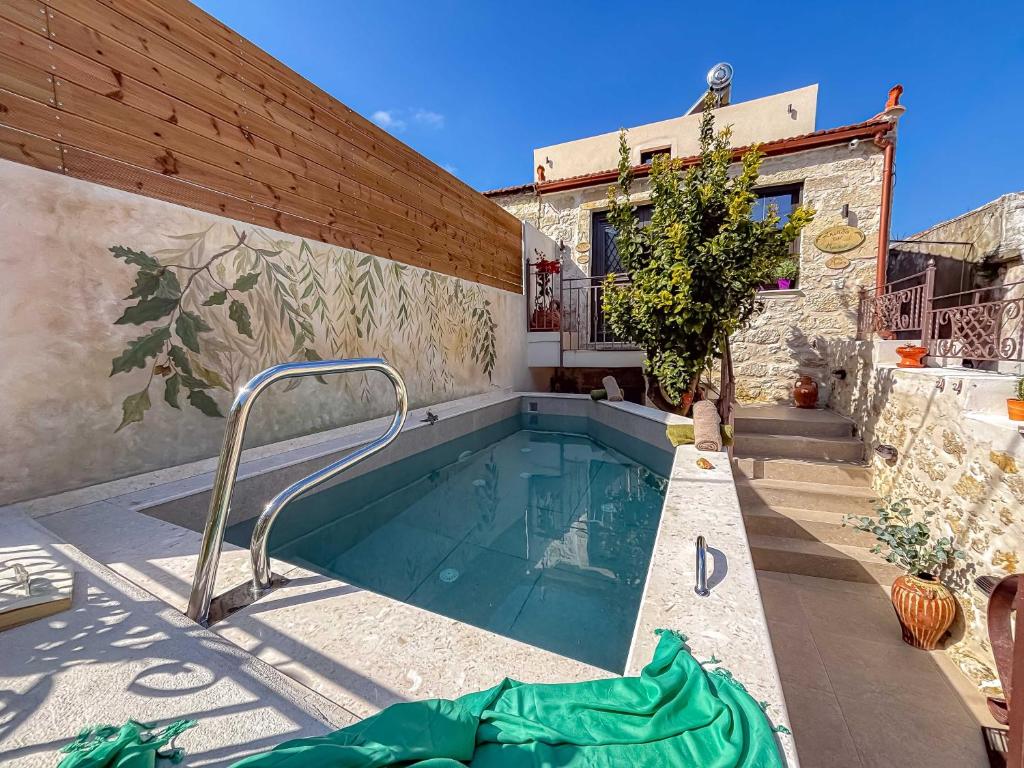 a swimming pool in the backyard of a house at Muses Mountain View in Ayía Varvára