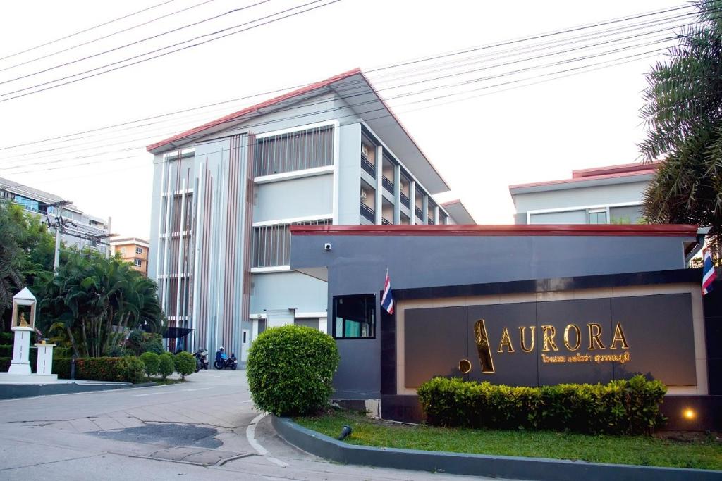a building with a sign for a hotel at Aurora Suvarnabhumi in Bang Hia