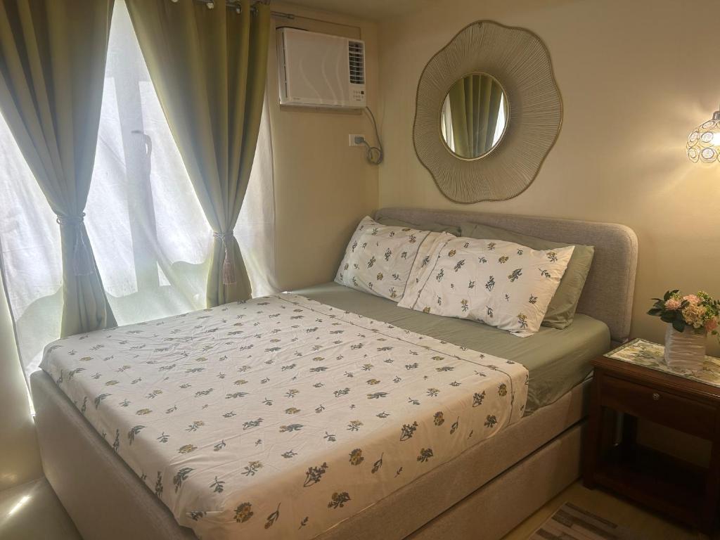 a small bed in a room with a window at Avida Tower 3 L21 staycation rm 117 in Iloilo City
