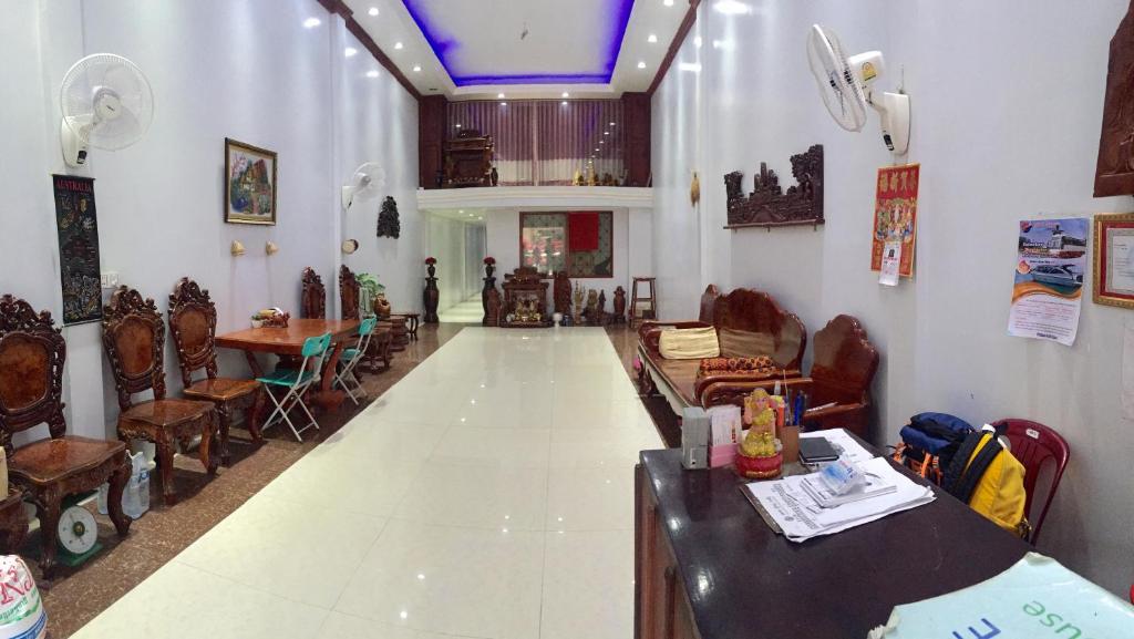 a living room with chairs and a table in a room at The Blue Guest House in Battambang