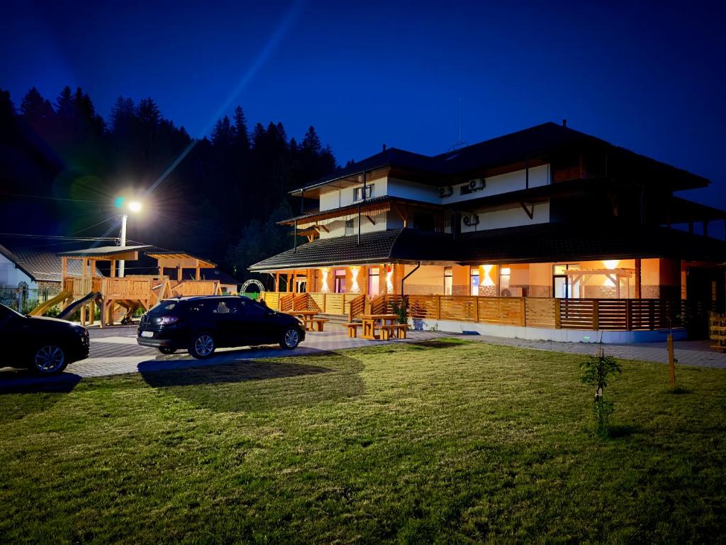 a building with a car parked in front of it at night at Vila Arina -Private Retreat in Voronet