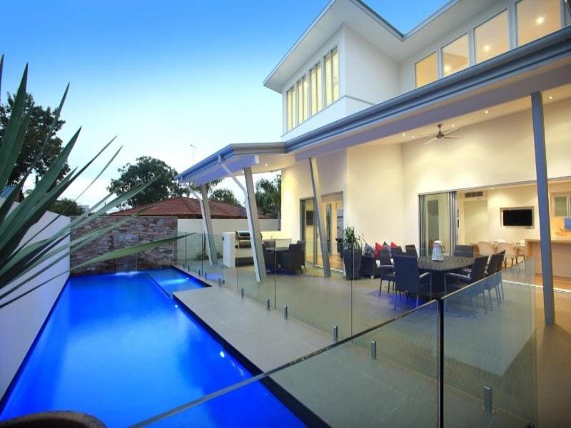 a house with a swimming pool in front of it at Luxury House steps from Mooloolaba Beach in Mooloolaba