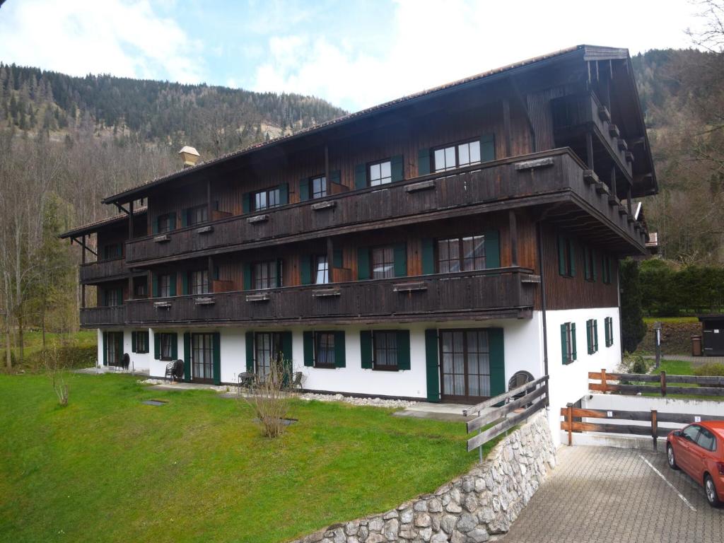 a large building with a car parked in front of it at Beautiful lodging in the Alps near Bayrischzell in Bayrischzell