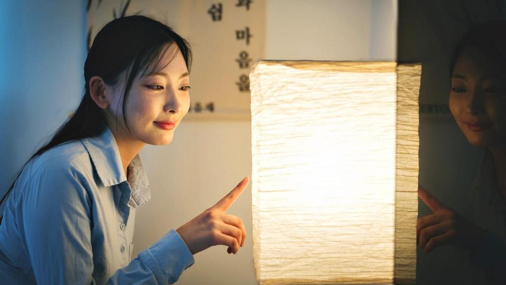 a woman pointing at a lamp with a woman pointing at Busan Ieumjae Seomyeon Station in Busan