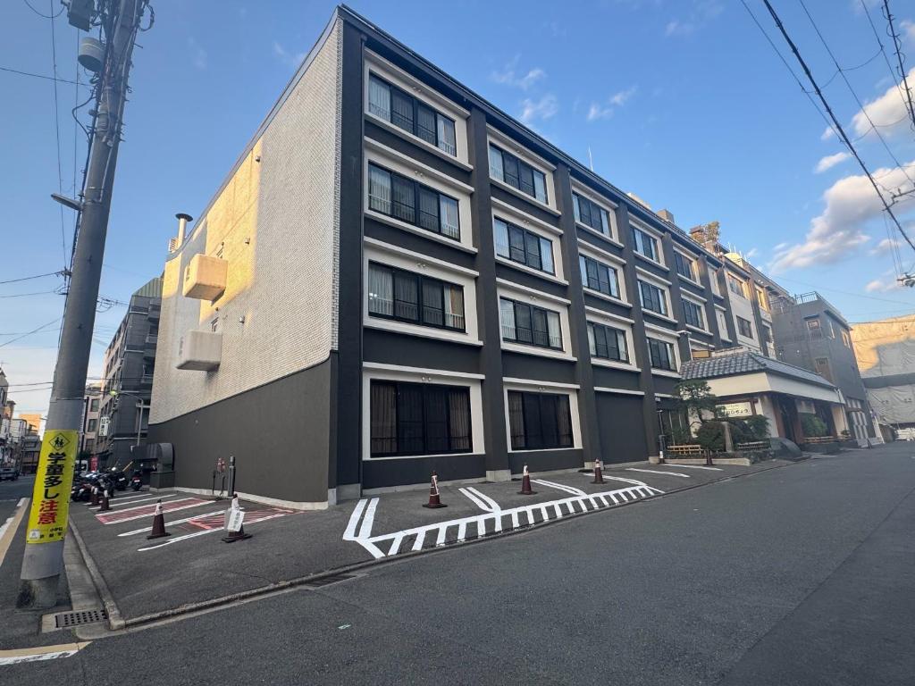 a large building on the side of a street at Ishicho in Kyoto