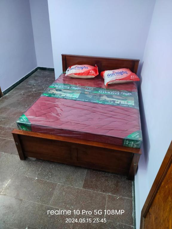 a bed with two pillows on top of it at APM Palace in Palaiya Ayakkudi