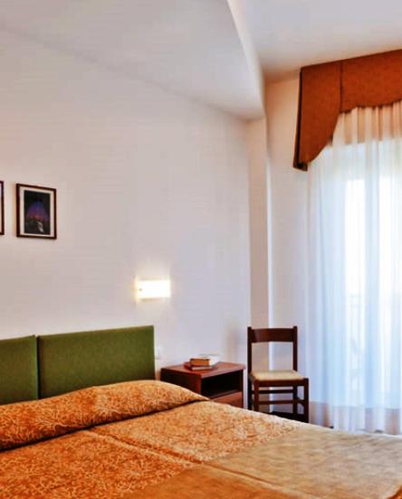 A bed or beds in a room at Hotel Gimm