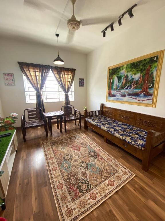 a living room with a couch and a table at Anggerik Camelia Homestay Apartment Ladang Tok Pelam FREE WIFI in Kuala Terengganu