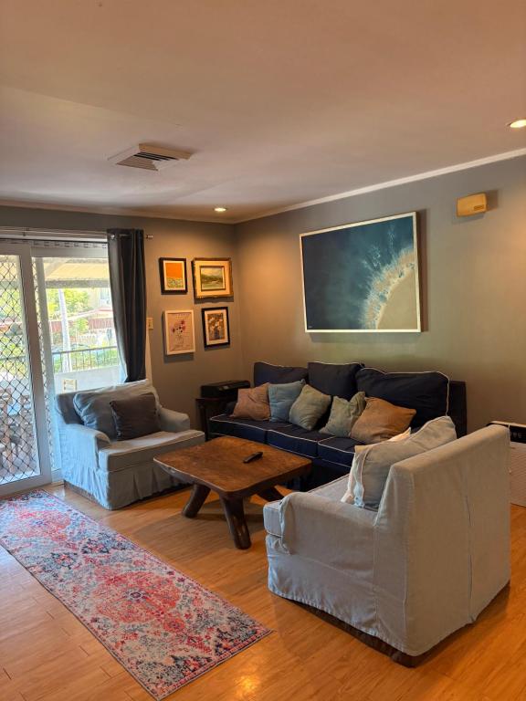 a living room with two couches and a table at A Pet Friendly Subic Bay Vacation Home in Olongapo