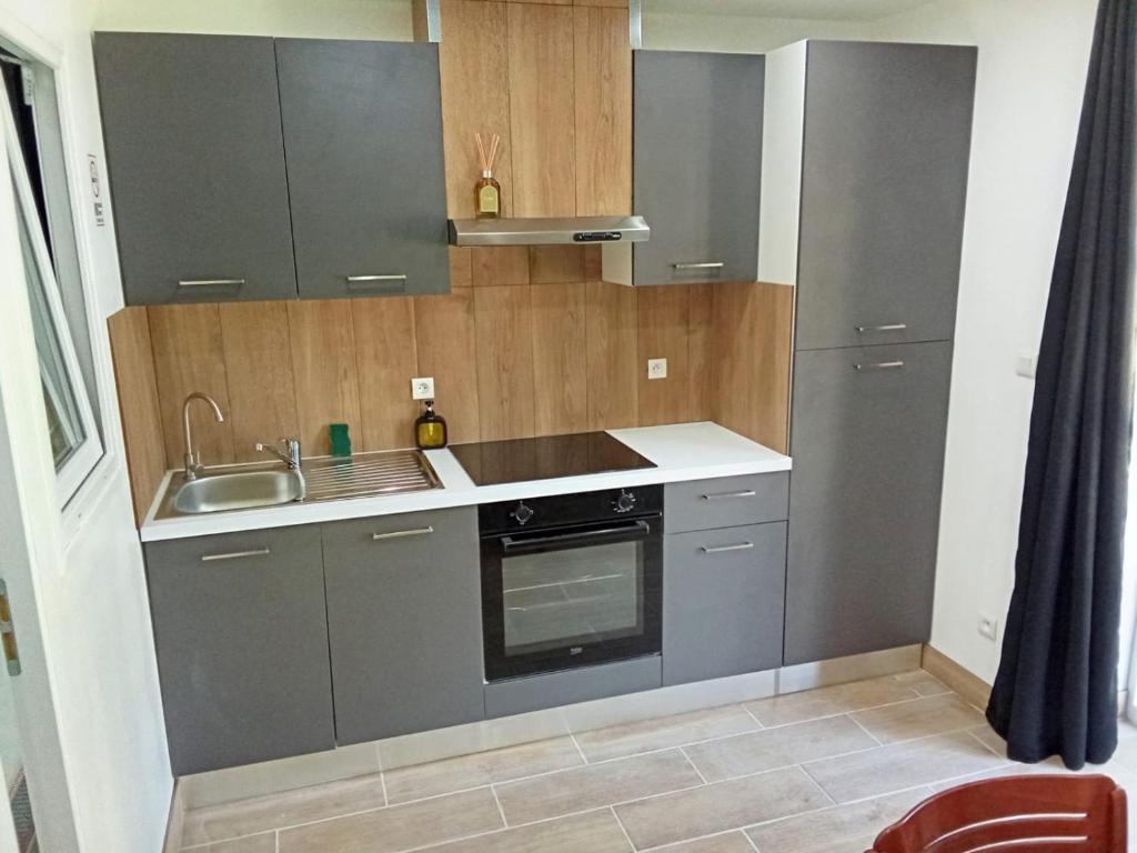 a kitchen with a sink and a stove at EVASION LOUE #6 x2 people "La BRIQUERIE" in Lods