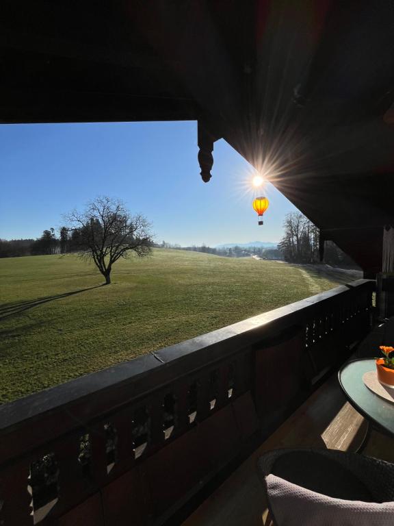 a view of a field from a window with a light at Ferienwohnung Gruberhof 250 m zum Chiemsee Uferweg in Rimsting