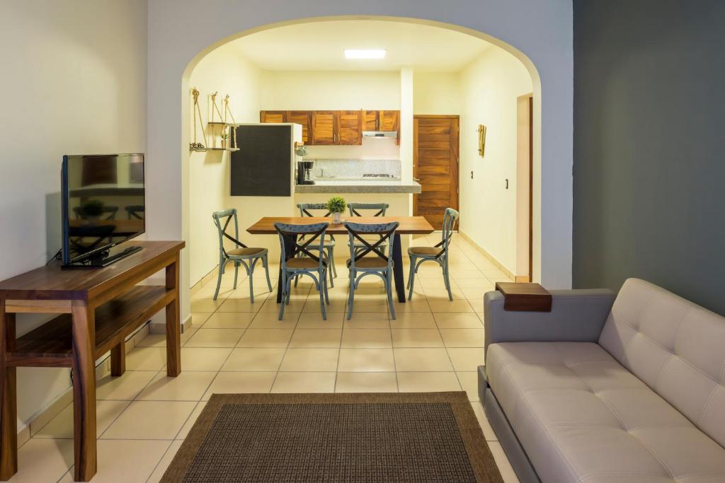 a living room with a couch and a table at Punto Mita Suites in Punta Mita