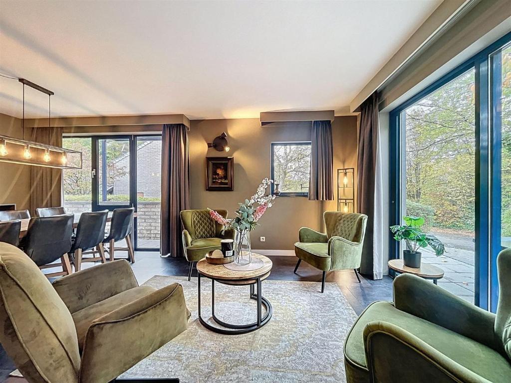 a living room with couches and chairs and a table at DURBUY au "trois marcassins" in Durbuy