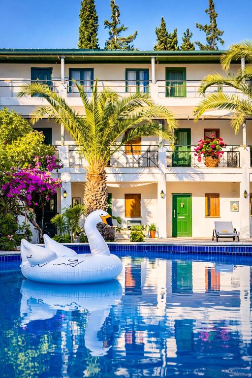 a swan float in the water in front of a hotel at Casa Blue Hotel All Inclusive in Bodrum City