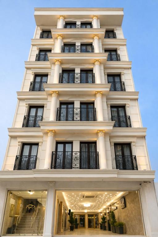 a tall white building with many windows at Rain Golden Hotel in Istanbul