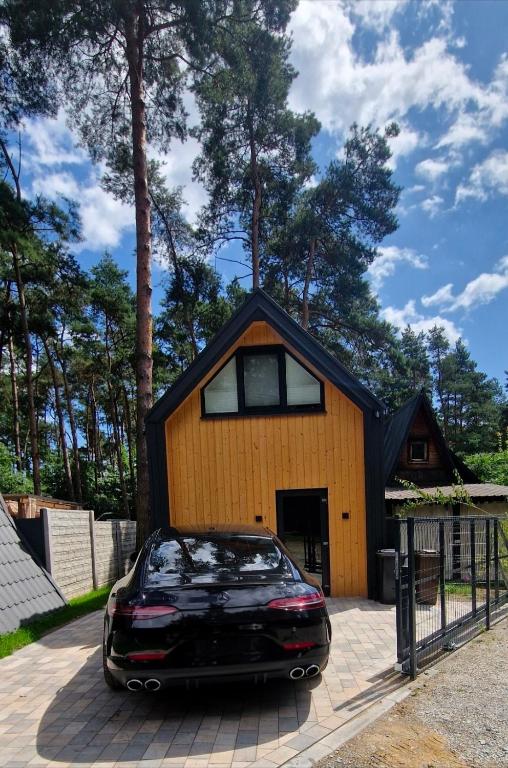 a car parked in front of a house at TomHouse in Skorochow