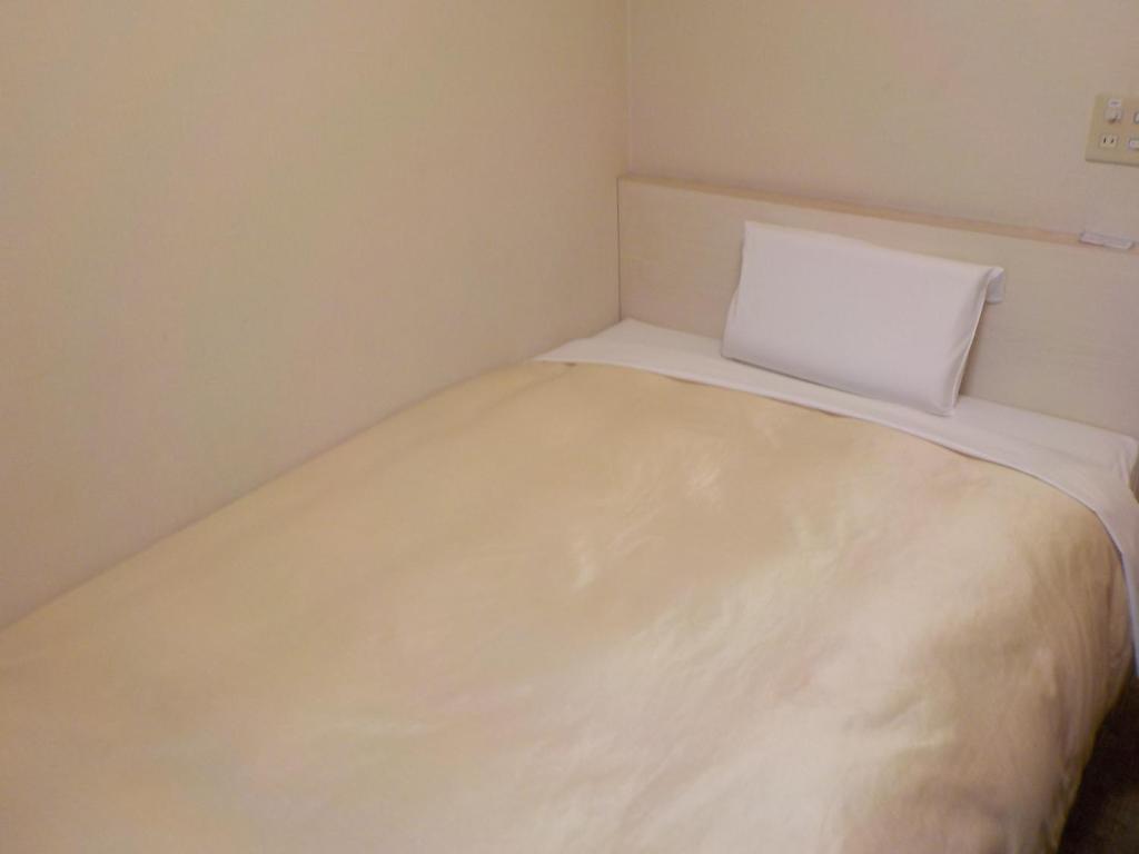 Postel nebo postele na pokoji v ubytování Hotel Crown Hills Katsuta Omotechoten