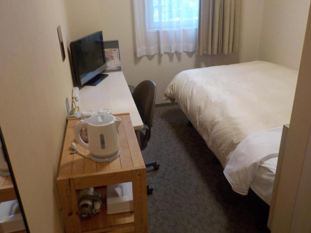 Postel nebo postele na pokoji v ubytování Hotel Crown Hills Katsuta Omotechoten
