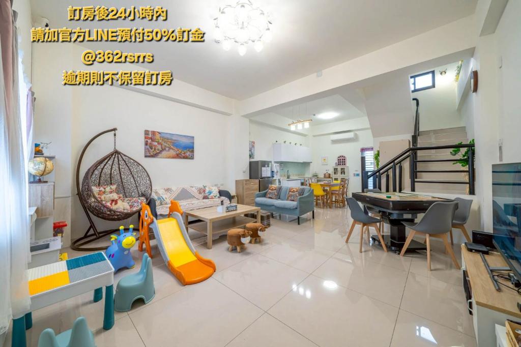 a living room with a play area with a swing at Sunlight Orchid Rain Homestay in Dongshan