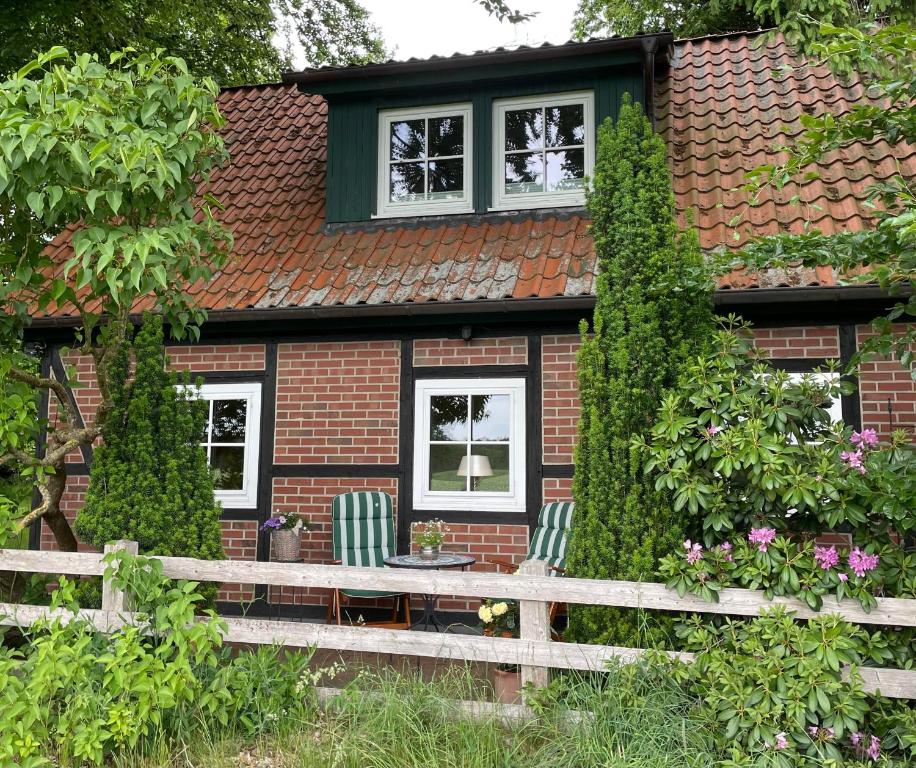a house with a bench in front of it at Heidenest in Soltau