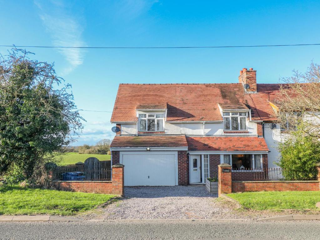 a large white house with a garage at Scamnel in Stafford