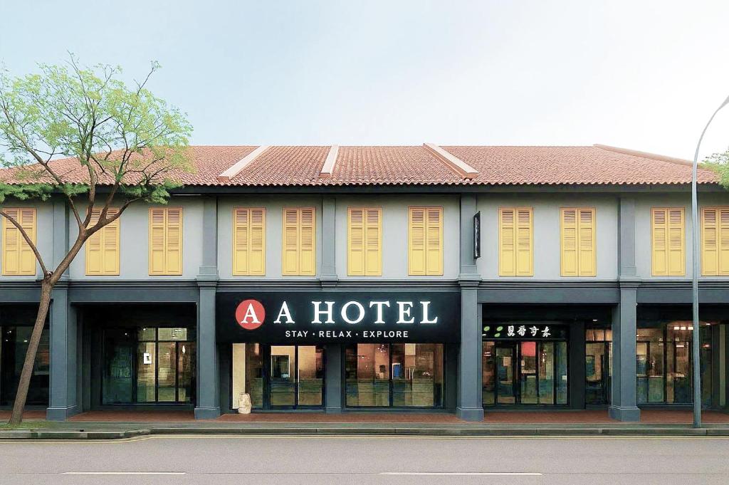 a hotel building with a hotel sign on it at A Hotel Joo Chiat in Singapore