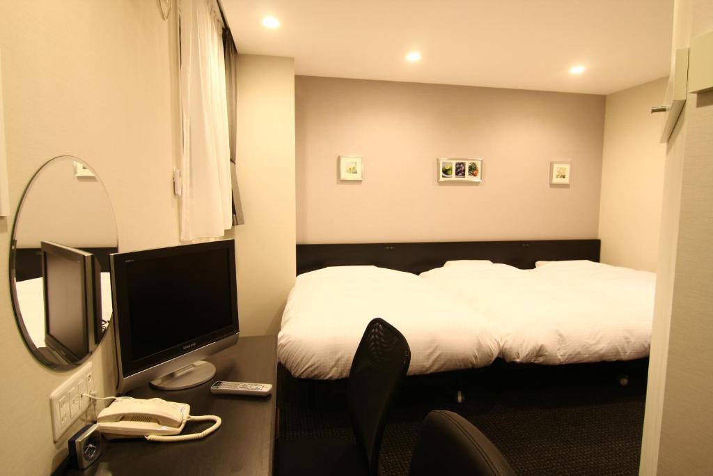 Postel nebo postele na pokoji v ubytování Hotel Crown Hills Kimitsu