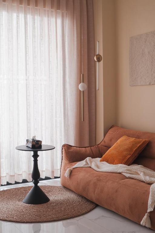 a living room with a couch and a table at Healing Home - Charm Ruby Apartment in Dĩ An
