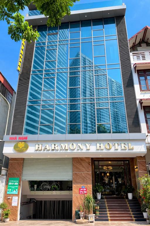 a large glass building with a harrahmy hotel at Harmony Hotel in Hanoi