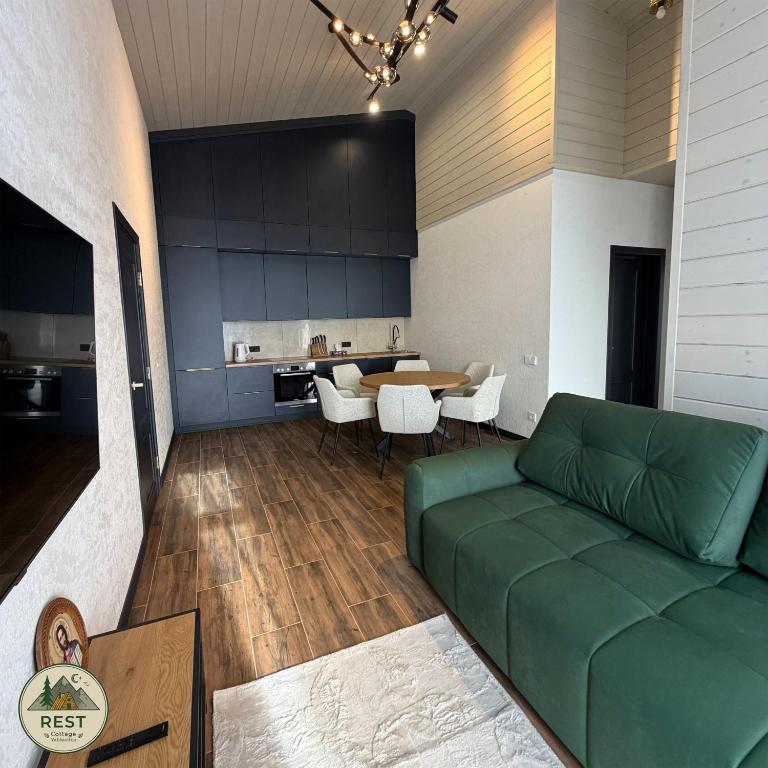 a living room with a green couch and a table at Rest in Yablunytsya