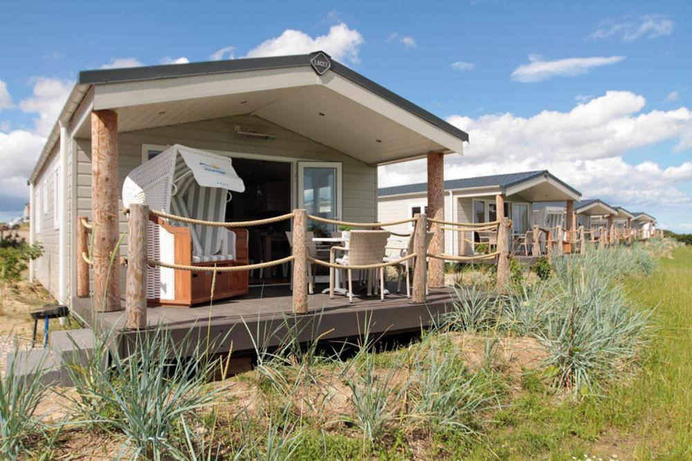 a small house with a deck on the beach at Ostseeferienpark Walkyrien in Schashagen