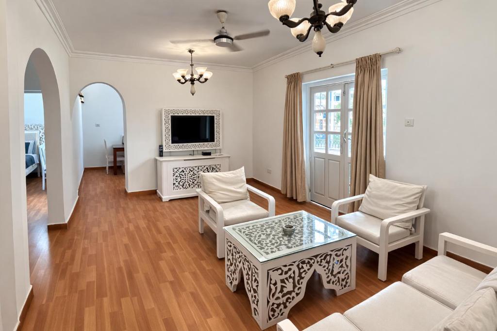 a living room with a couch and a table at Lilly candolim apartment in Candolim