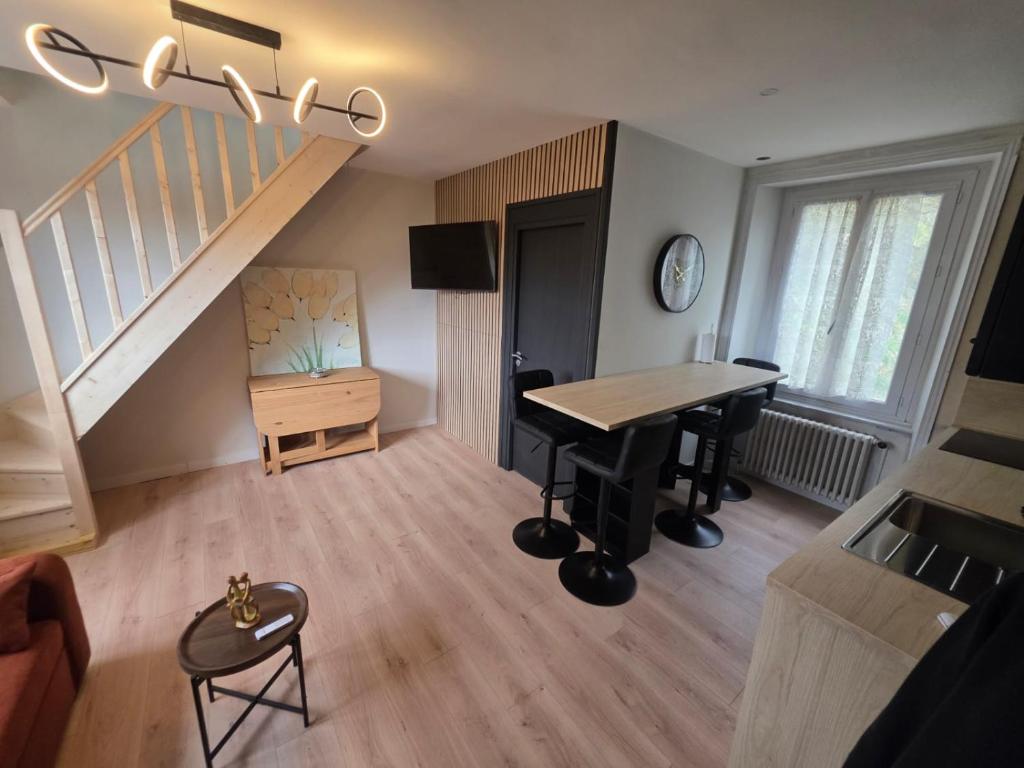 a living room with a piano and a staircase at L'aulne in Carhaix-Plouguer
