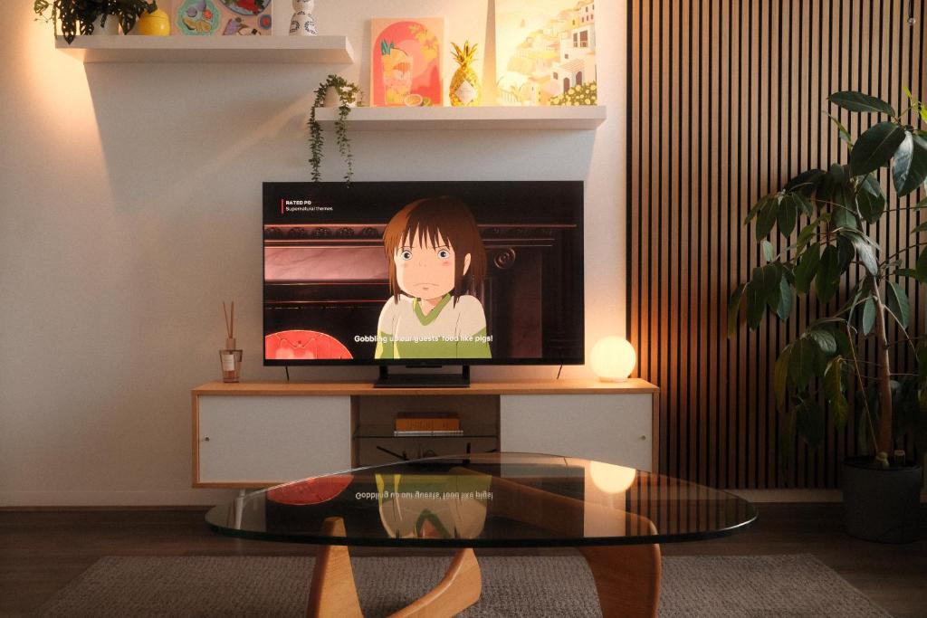 a tv sitting on a table in a living room at Chapel Street Hideaway in Melbourne