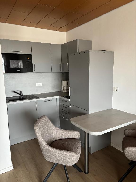 a small kitchen with a table and two chairs at Apartment Dargies in Cuxhaven