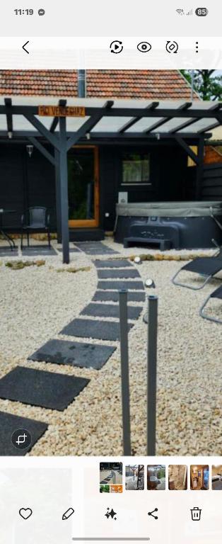 a picture of a stone walkway in front of a building at Pici vendégház in Noszvaj