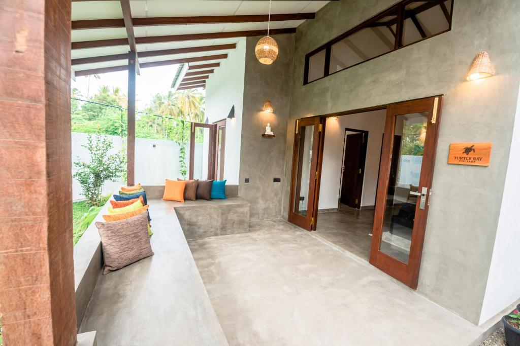 an indoor hallway of a house with a glass door at Turtle Bay Cottage in Kosgoda