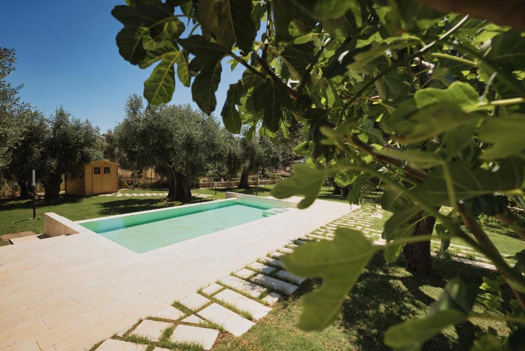 a swimming pool in a yard with trees at Pilone del Monaco - Pool & Free Parking in Vieste
